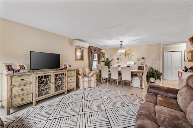 tiled living room featuring a wall unit AC and an inviting chandelier