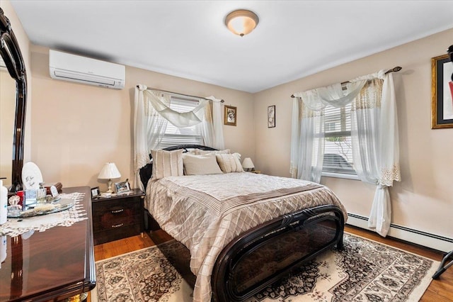 bedroom with wood-type flooring and a wall mounted AC