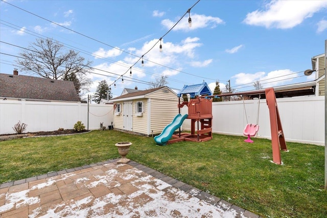 exterior space featuring a lawn, an outbuilding, and a patio