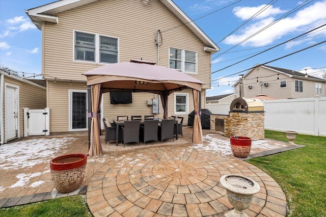 back of property featuring a gazebo, area for grilling, and a patio