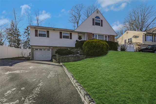 view of front of home with a front lawn and a garage