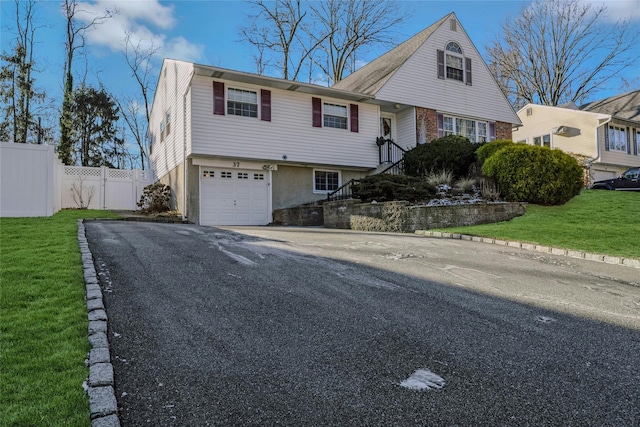 view of front of property with a front yard and a garage