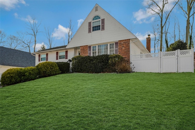 cape cod home with a front lawn