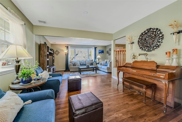 living room with dark hardwood / wood-style flooring and baseboard heating