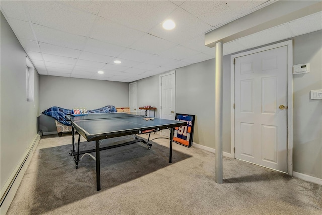 playroom featuring a baseboard heating unit, a drop ceiling, and carpet