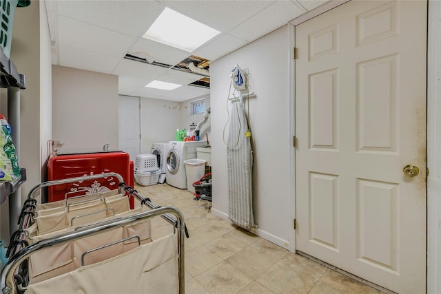 laundry room with washer and dryer and light tile patterned floors