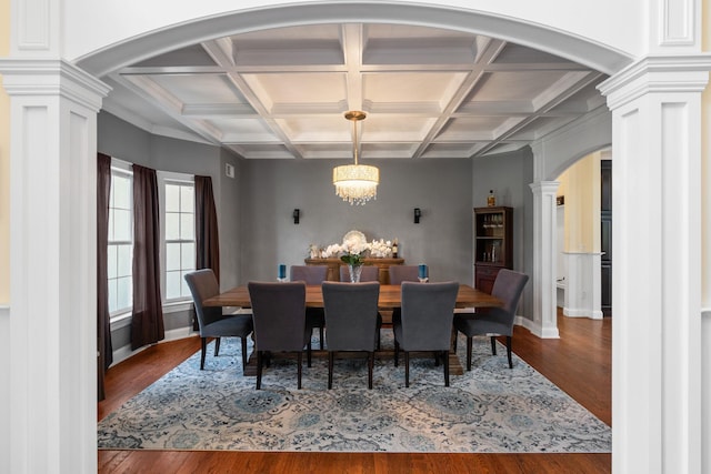 dining area with wood-type flooring, coffered ceiling, decorative columns, and beam ceiling