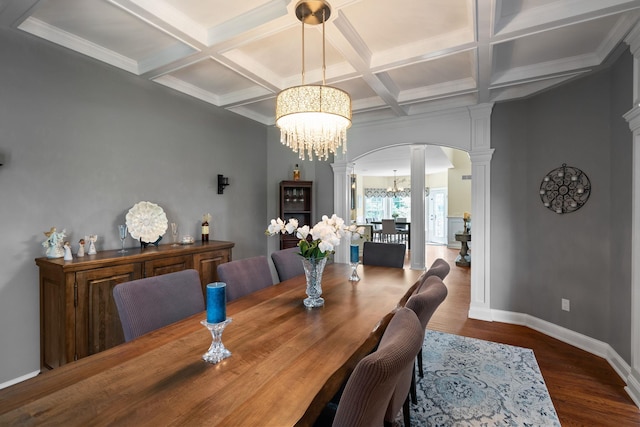 dining area with ornate columns, dark hardwood / wood-style floors, coffered ceiling, an inviting chandelier, and beamed ceiling