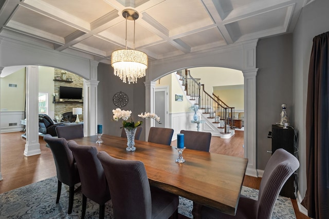 dining room with beam ceiling, wood-type flooring, ornate columns, and coffered ceiling