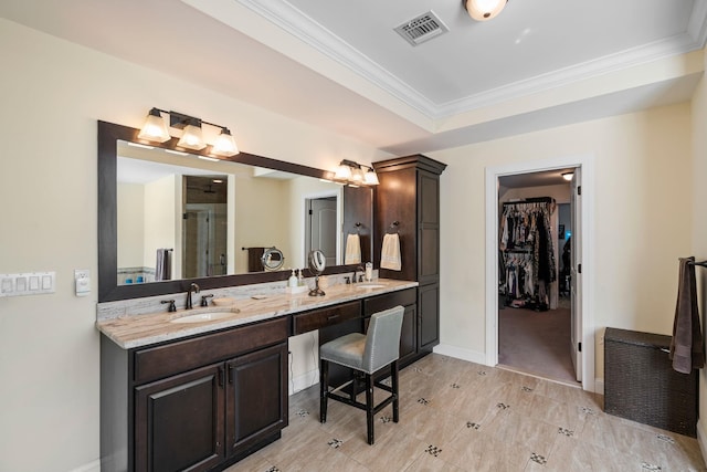 bathroom featuring ornamental molding and vanity