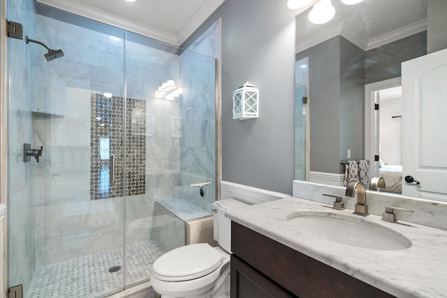 bathroom featuring toilet, vanity, a shower with shower door, and ornamental molding