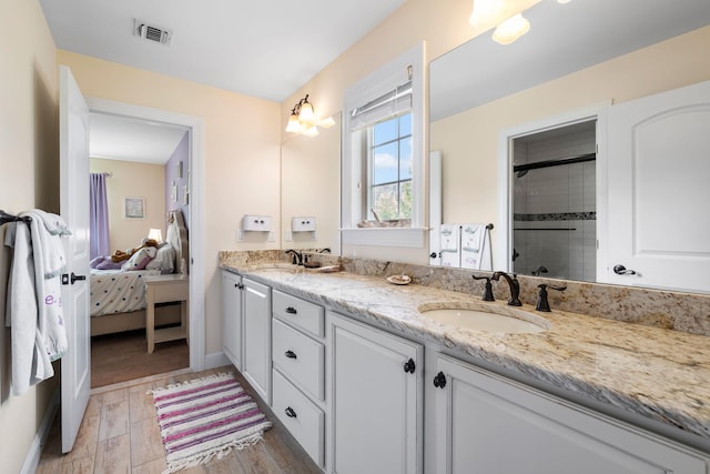 bathroom featuring an enclosed shower and vanity