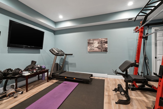 exercise room featuring hardwood / wood-style floors