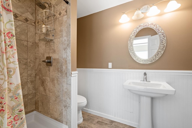 bathroom with a shower with curtain and toilet