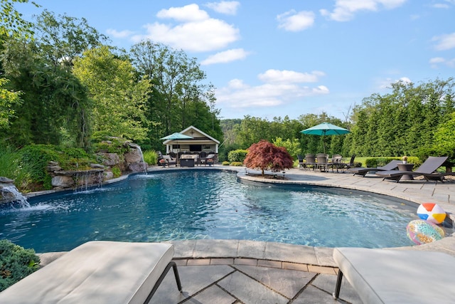 view of swimming pool with a patio area and pool water feature