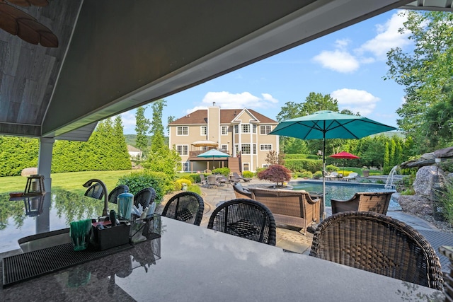 view of patio / terrace with pool water feature