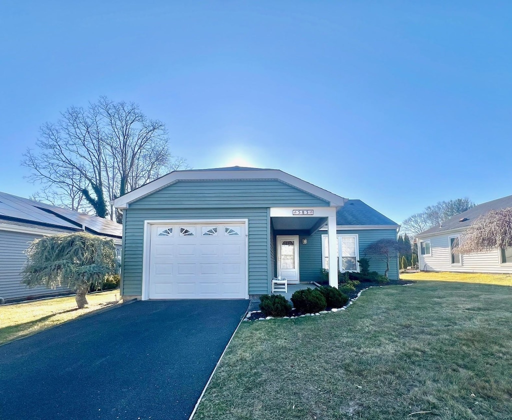 view of front facade with a front yard and a garage