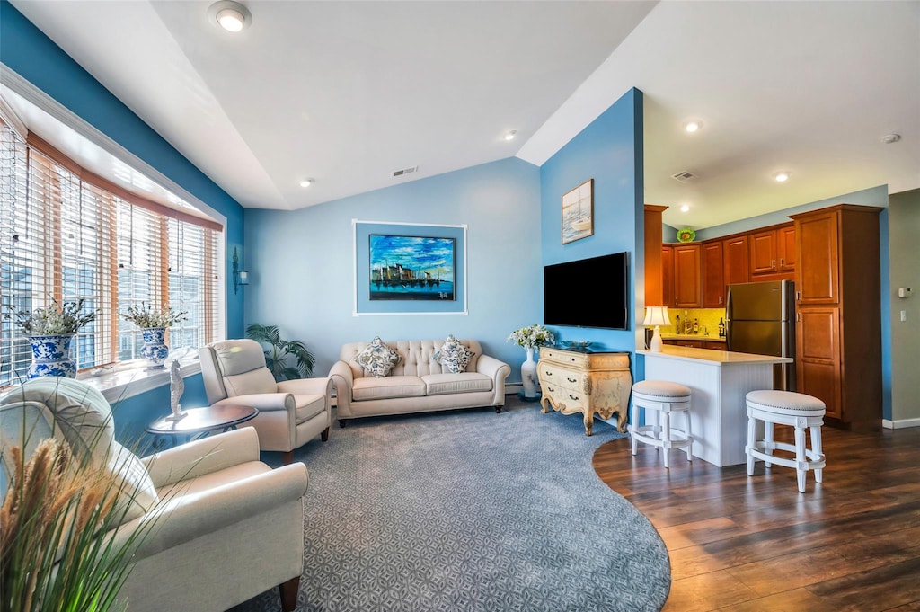 living room with dark hardwood / wood-style flooring and vaulted ceiling