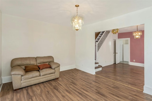 living room with dark wood-type flooring and a chandelier