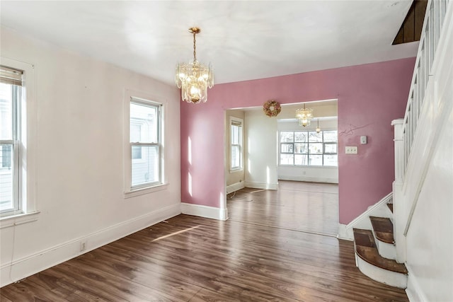 interior space with dark wood-type flooring and a notable chandelier