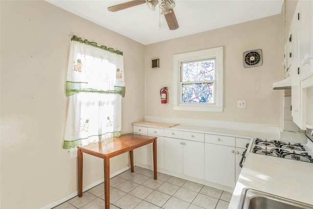 kitchen featuring white cabinetry, ceiling fan, and light tile patterned flooring