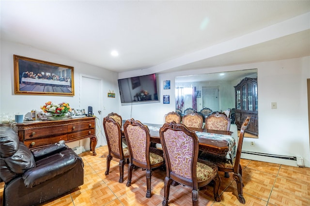 dining room with light parquet flooring and a baseboard heating unit