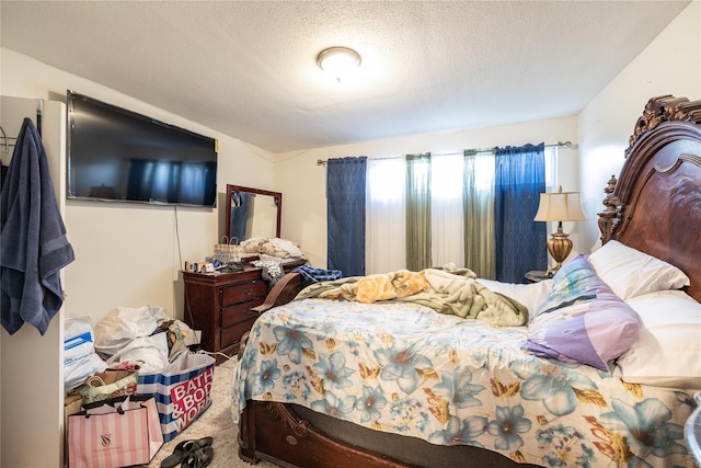 carpeted bedroom featuring a textured ceiling