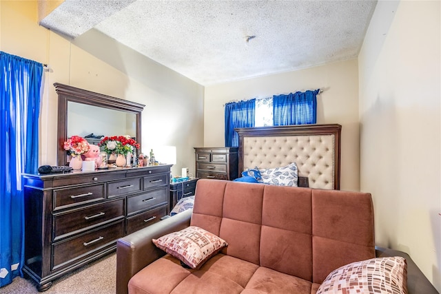 carpeted bedroom featuring a textured ceiling