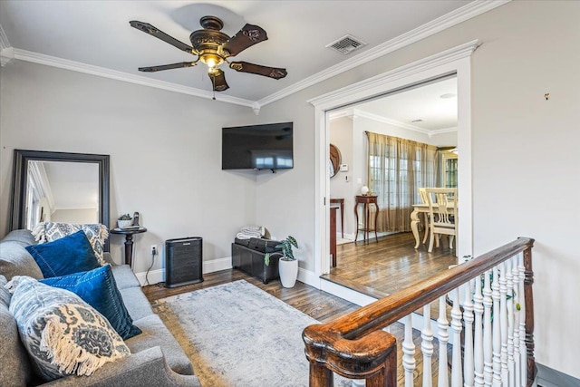 living room with ceiling fan, wood-type flooring, and crown molding