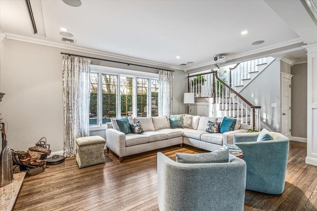 living room featuring crown molding, ornate columns, and hardwood / wood-style flooring