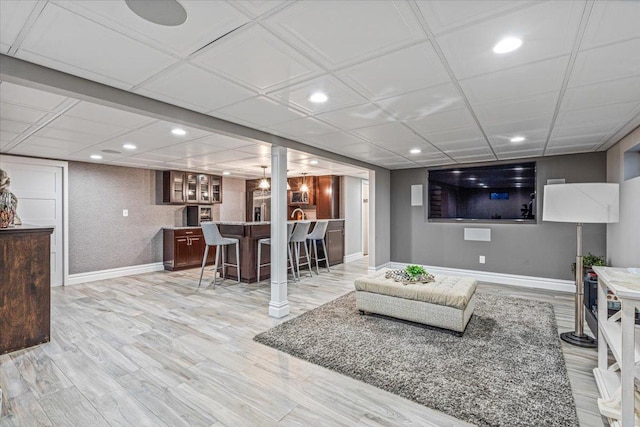 living room featuring light hardwood / wood-style floors and bar area