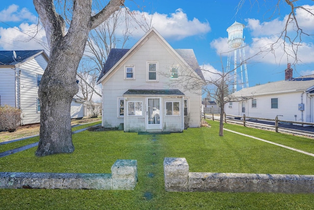 back of property featuring an outdoor structure and a yard