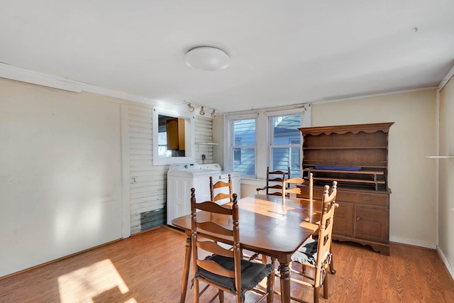 dining space featuring separate washer and dryer and light wood-type flooring