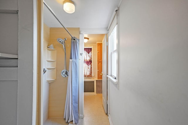 hallway with a healthy amount of sunlight and ornamental molding