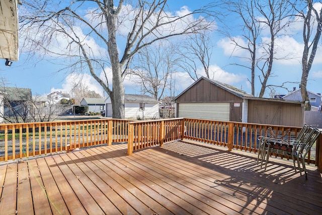 wooden terrace with a garage and an outbuilding