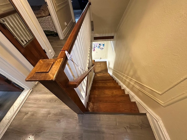 stairs featuring hardwood / wood-style floors