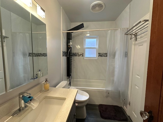 full bathroom featuring vanity, shower / bath combination with curtain, and toilet