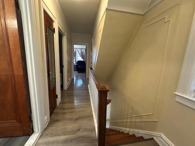 hallway with hardwood / wood-style flooring