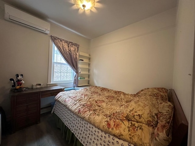 bedroom with a wall unit AC and dark hardwood / wood-style floors