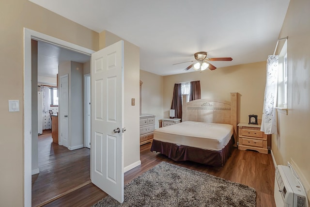 bedroom featuring a wall mounted air conditioner, ceiling fan, and dark hardwood / wood-style floors