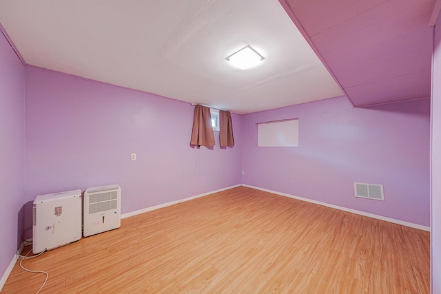 basement featuring hardwood / wood-style floors