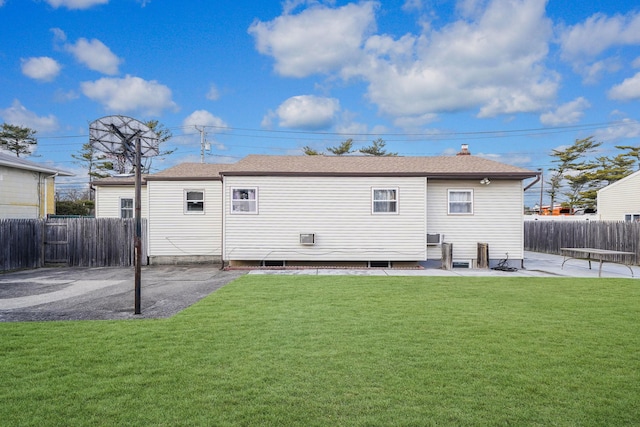 back of property with a yard and a patio