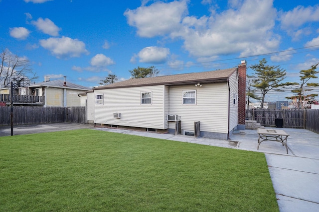 back of property with a yard and a patio area