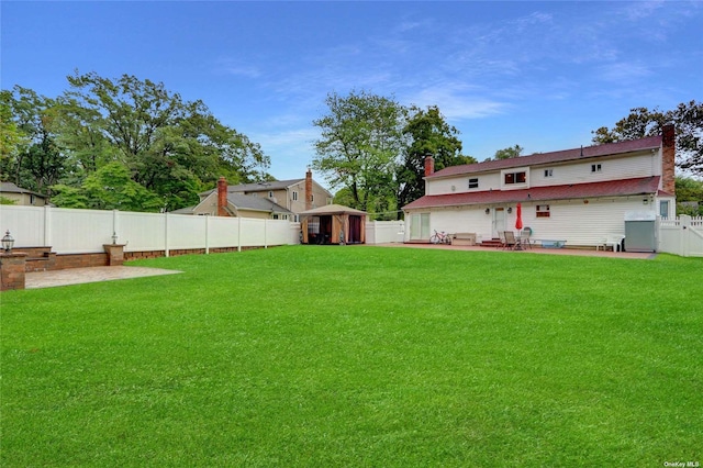 view of yard featuring a patio area and a fenced backyard