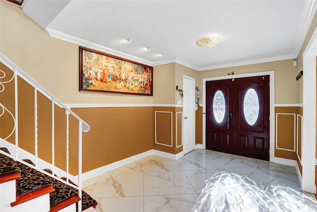 foyer featuring marble finish floor, crown molding, stairway, and baseboards