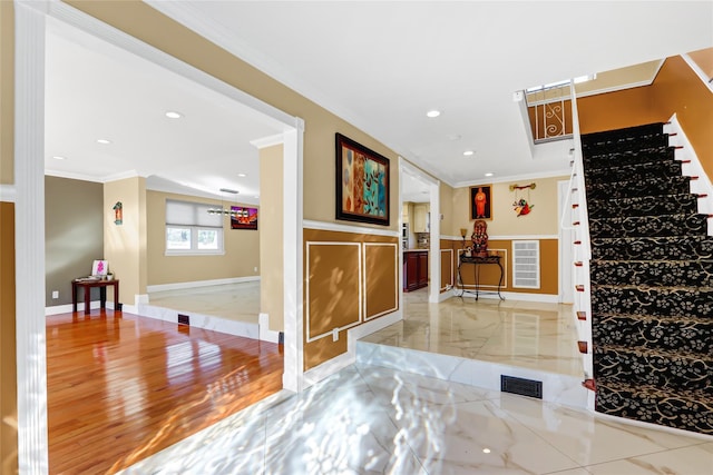 foyer featuring ornamental molding, marble finish floor, visible vents, and stairs