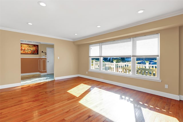 unfurnished room with ornamental molding, recessed lighting, baseboards, and hardwood / wood-style floors