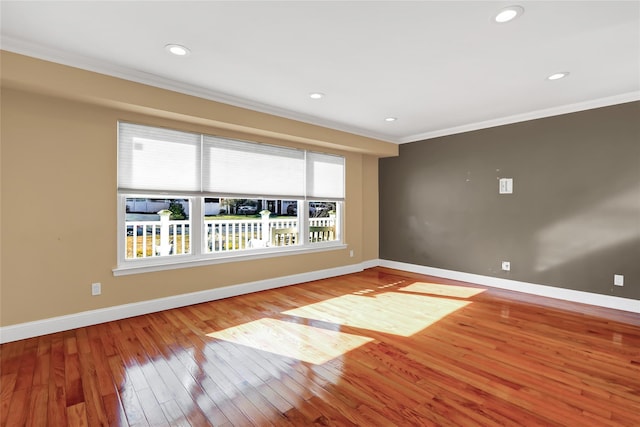 empty room with ornamental molding, a healthy amount of sunlight, and baseboards