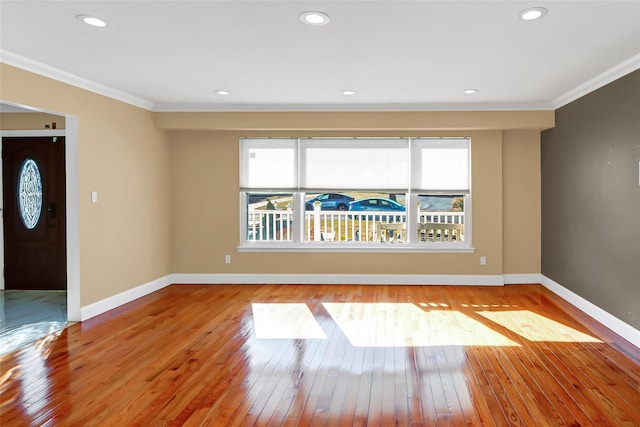 interior space featuring wood-type flooring, baseboards, crown molding, and recessed lighting