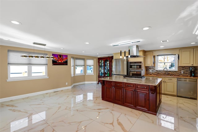 kitchen featuring marble finish floor, wall chimney exhaust hood, appliances with stainless steel finishes, and a sink